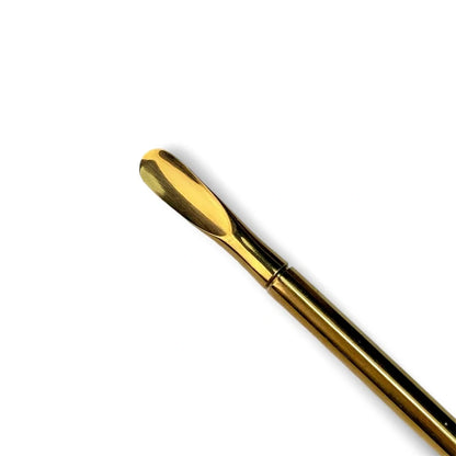 one side of a gold metal double ended cuticle pusher