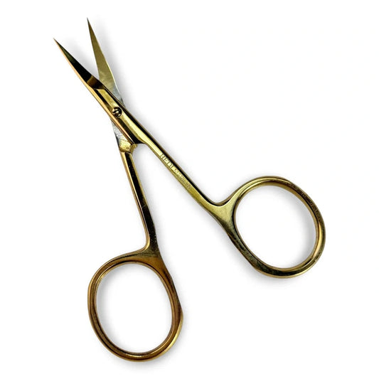 A pair of small gold-colored metal scissors with circular finger rings, shown on a plain white background.